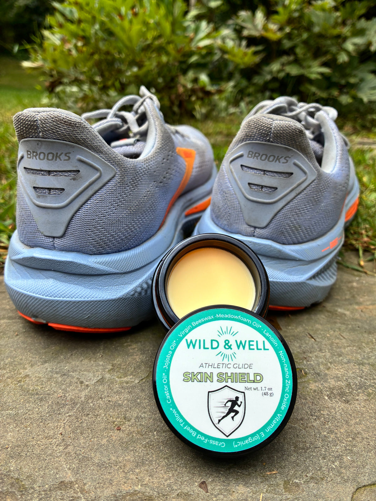 Wild & Well Skin Shield balm in amber glass jar